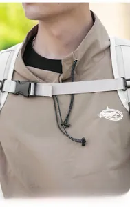 Close-up of white plastic buckle and adjustable straps on a minimalist khaki outdoor backpack