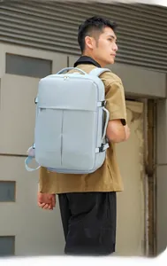 Light blue business travel backpack featuring side buckles and water-resistant fabric