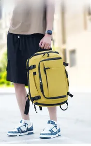 Outdoor shot of bright yellow multi-pocket backpack with durable nylon and side buckles