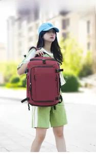 Outdoor view of a large burgundy travel backpack with multiple zipper layers and straps