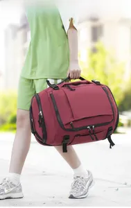 Close-up of durable dark red travel backpack featuring waterproof zippers and side buckles