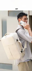 Outdoor view of a large cream-white business travel backpack with side adjustable straps