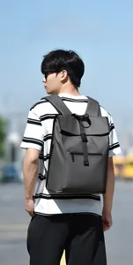 Detail of dark grey commuter backpack with buckle closure and waterproof fabric texture