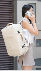 Detailed side view of beige travel backpack with USB port and adjustable compression straps