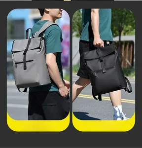 Waterproof large capacity laptop backpack showing flap buckles and padded straps in street setting
