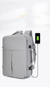 Detail of grey travel backpack featuring integrated USB charging port and side handle