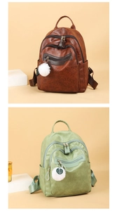 Detail view of stylish soft PU leather backpacks in brown and green with multi-zipper pockets
