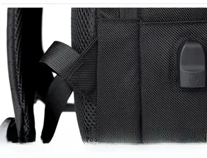Detail of reinforced shoulder strap stitching and durable plastic buckle on the black backpack
