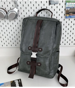 Detail of dark PU leather backpack featuring brown straps and quick-release buckle closures