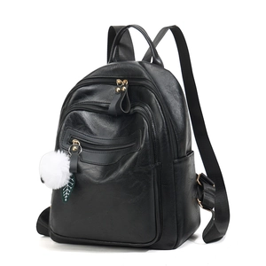 Minimalist black PU leather backpack for women with plush charm in a 45-degree side view