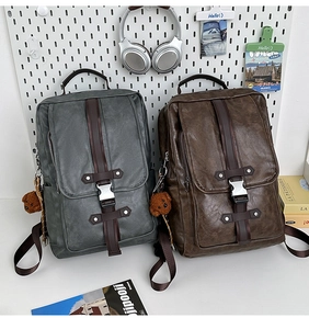 Detail of vintage PU leather backpack showing metal buckles and cute bear charm