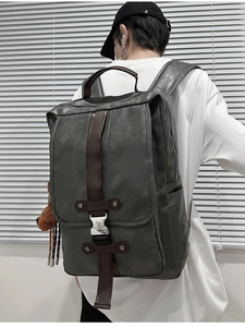 Close-up of vintage dark grey PU leather backpack with metallic buckle and flap detail