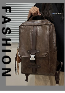 Close-up of brown PU leather backpack texture with woven tassel and metal buckles