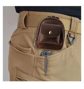 Close-up of a brown leather waist pouch with a belt loop for outdoor tactical gear