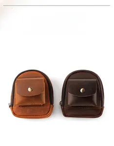 Detail view of leather mini waist pouches in caramel and dark brown with metal snaps
