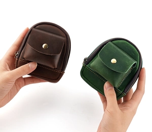 Detail of vintage leather mini waist bags in dark brown and emerald green colors