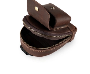 Detail view of brown leather belt pouch with zip pocket and brass snap button