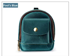 Macro shot of crazy horse leather blue mini pouch with metal snap and zipper