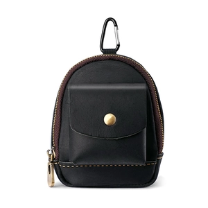 Close-up of black leather mini waist bag with brass buckle and yellow stitching detail