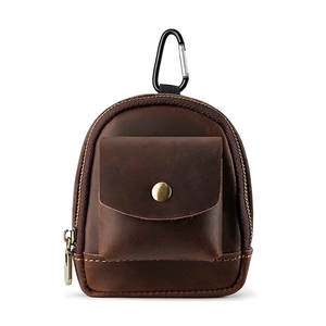 Macro detail of dark brown leather mini pouch with metal carabiner and bronze snap button