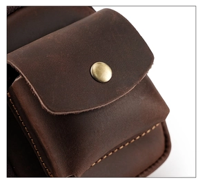Detailed macro view of retro brown genuine leather texture with bronze snap button