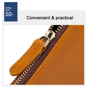 Detail of vintage copper zipper on brown crazy horse leather wallet with fine stitching