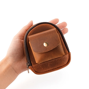 Brown vintage crazy horse leather waist coin purse held in hand for size display