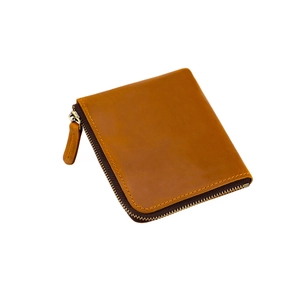 Detailed macro view of a brown crazy horse leather wallet with vintage metal zipper