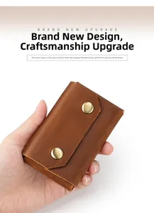 Close-up of vintage brown cowhide card case with metallic snaps and handcrafted texture