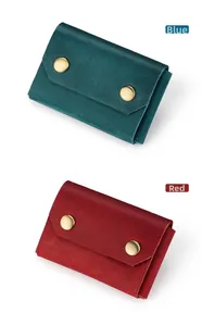 Detail view of crazy horse leather card holders in blue and red with double snap closure