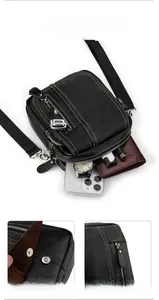 Detail of lychee leather crossbody bag showing large capacity main compartment and hardware