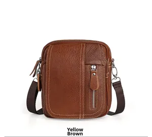 Close-up of yellow brown pebble grain leather crossbody bag with yellow stitching details