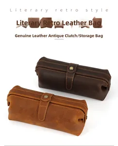 Macro shot of two vintage genuine leather toiletry bags with rustic metal buckle closure