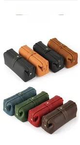 Detailed view of genuine leather toiletry bags with vintage stitching and metal snaps