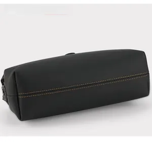 Detail view of premium black leather pouch showing durable double yellow stitching texture