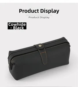 Detailed view of genuine black leather toiletry bag with orange stitching and buckle strap