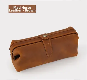 Detail view of brown crazy horse leather pouch showing high-quality texture and metal snap button