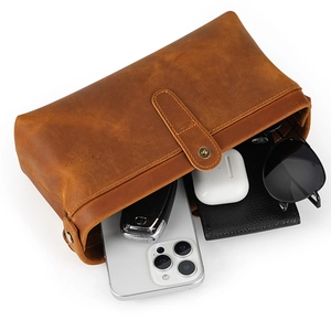 Retro brown genuine leather toiletry bag showing large capacity and button strap closure