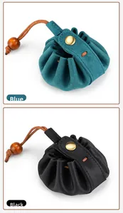 Detail of leather drawstring coin pouches in blue and black with wooden beads and metal snaps