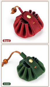 Detail of red and green crazy horse leather coin pouches with drawstring and metal clasp