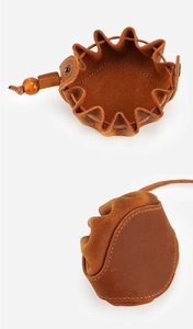 Detail of vintage brown crazy horse leather coin purse with drawstring and wooden bead