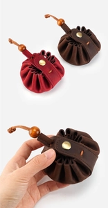 Detail of vintage crazy horse leather drawstring coin pouch with wood beads and snap button