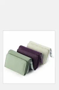 Three-fold leather wallets in mint green, purple and beige with pebbled texture
