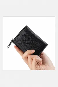 Detail of compact black pebble grain leather wallet with metal zipper and RFID protection
