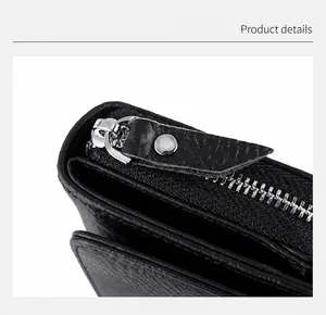 Detailed macro view of the smooth silver metal zipper and black leather puller