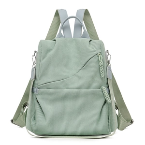 Versatile mint green corduroy backpack with multi-way straps and woven zipper detail