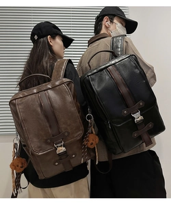Detailed view of vintage PU leather backpacks with metal buckles and teddy bear charms