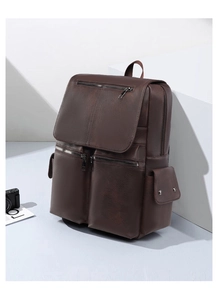 Detailed view of dark brown PU leather backpack with multiple pockets and vintage texture