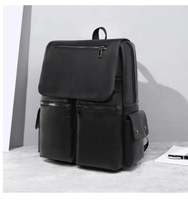 Macro detail of black leather business backpack with multi-pocket design and metal zippers