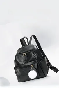 Detail view of lightweight 0.45kg black PU leather backpack with decorative plush pendant